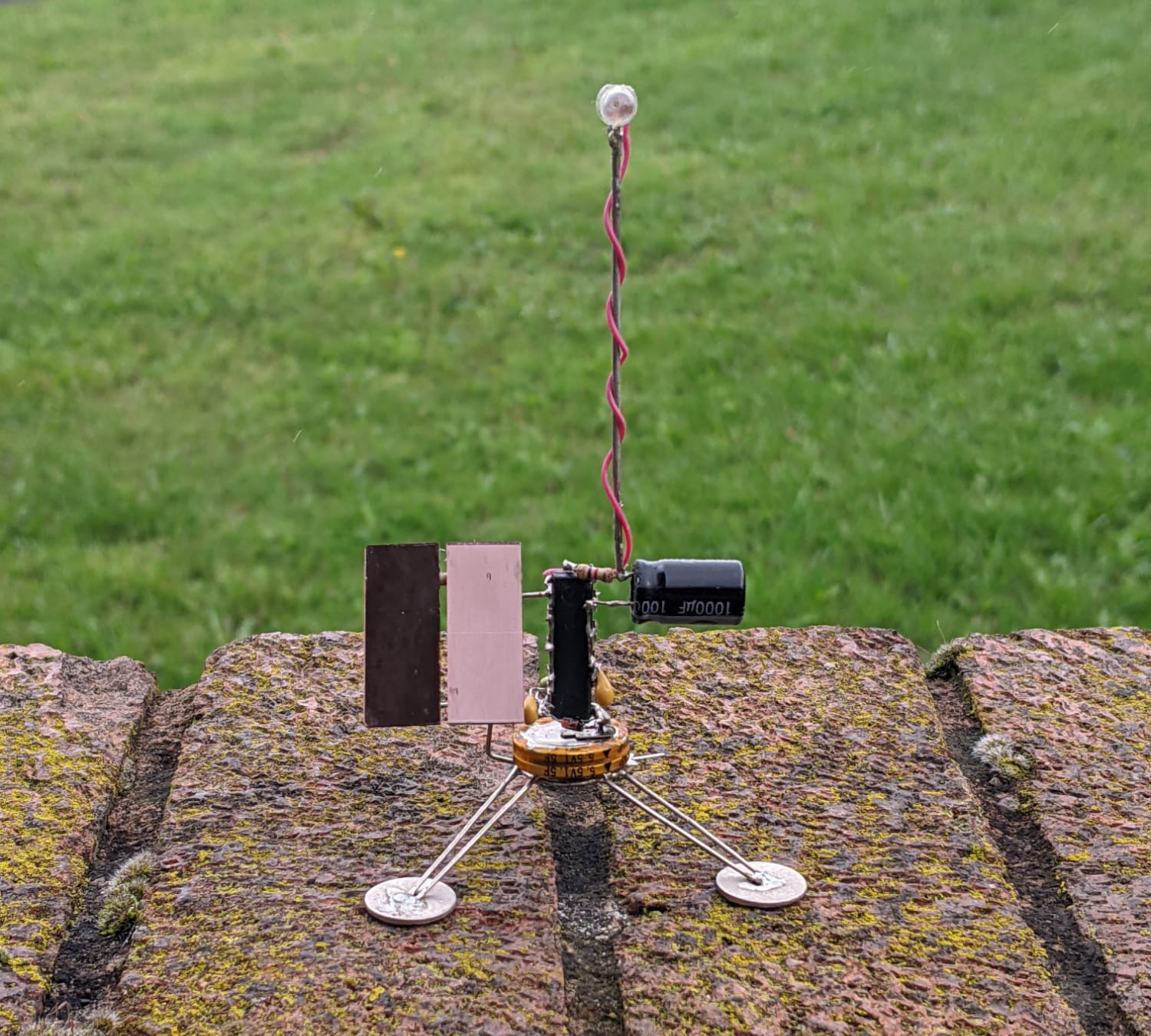 Satellite-like robot with flashing LED.